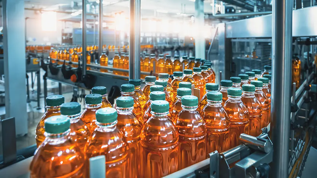 Automated bottling line for fruit juice in a factory.