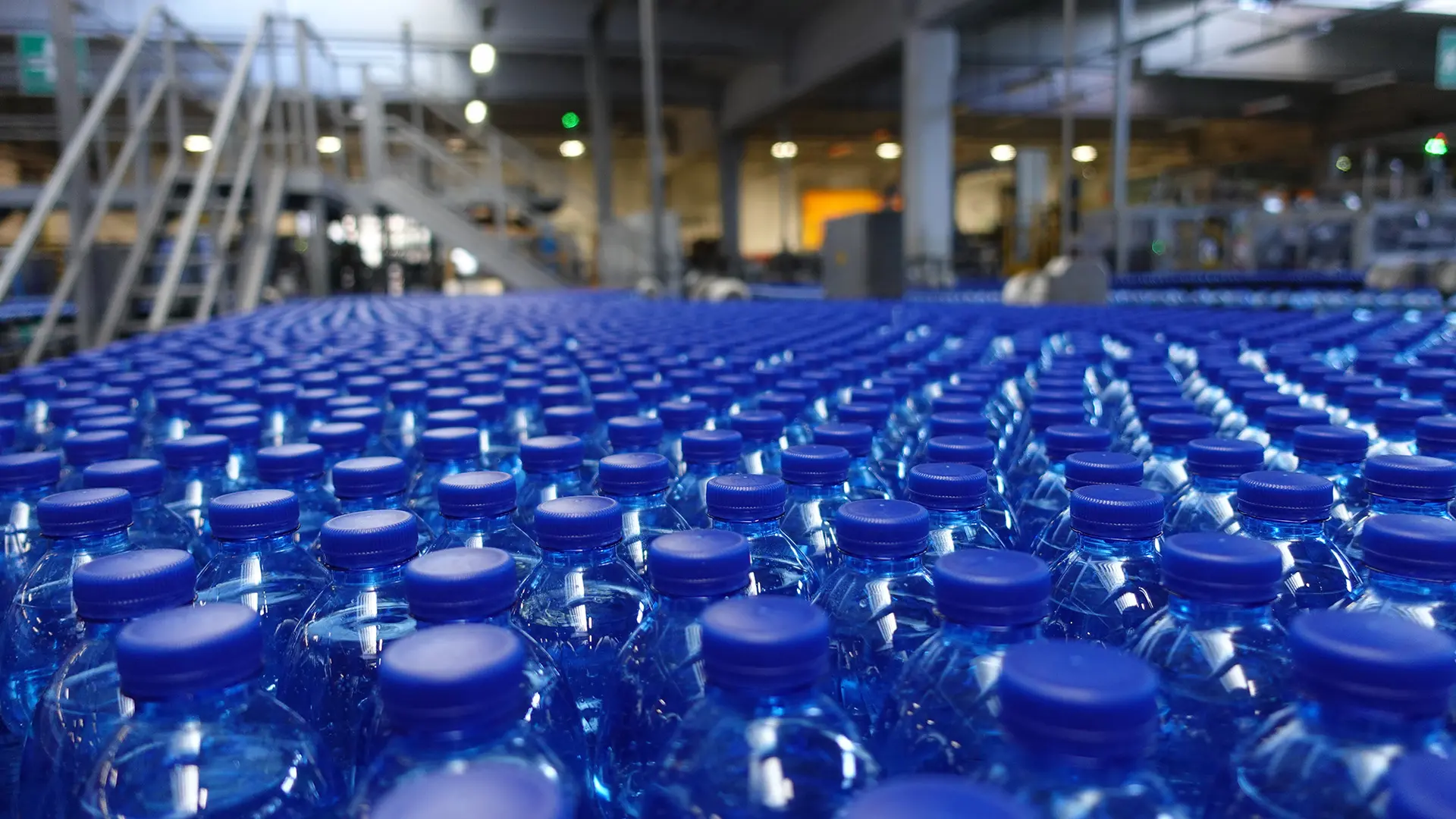 Image of a water bottling plant with bottles and Decimo handle machine.